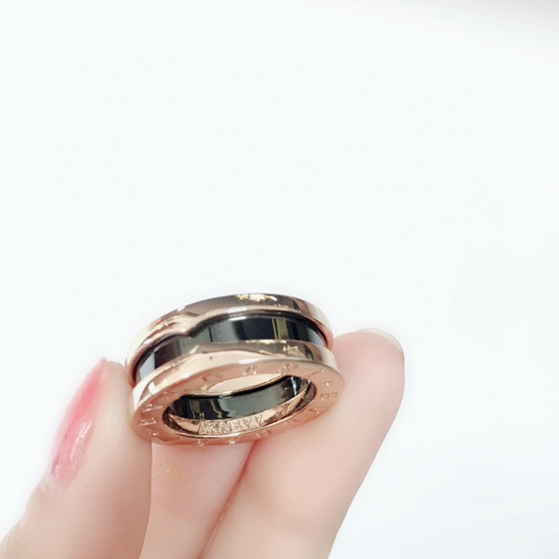 B.zero1 two-band ring with two 18 kt rose gold loops and a black ceramic spiral.