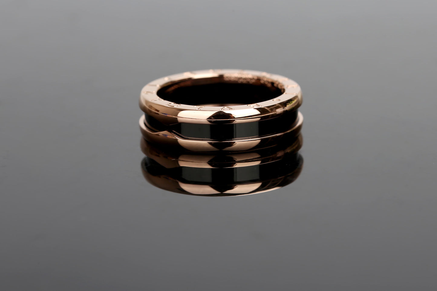 B.zero1 two-band ring with two 18 kt rose gold loops and a black ceramic spiral.