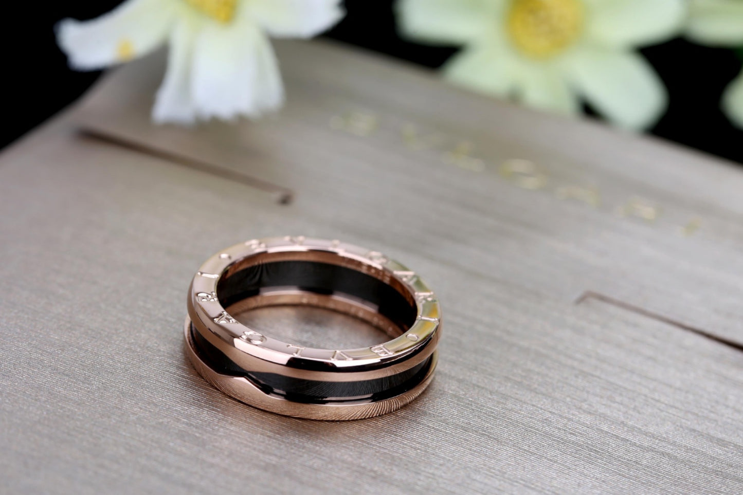 B.zero1 two-band ring with two 18 kt rose gold loops and a black ceramic spiral.